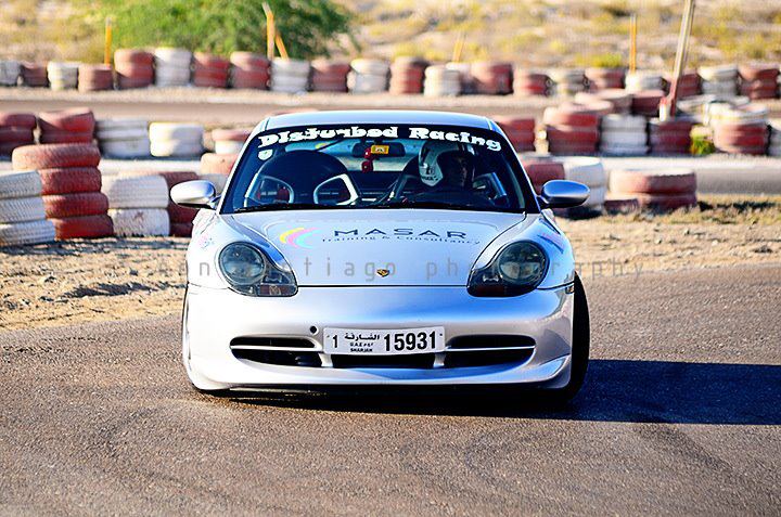 Nabil’s silver racing car taking a corner on track
